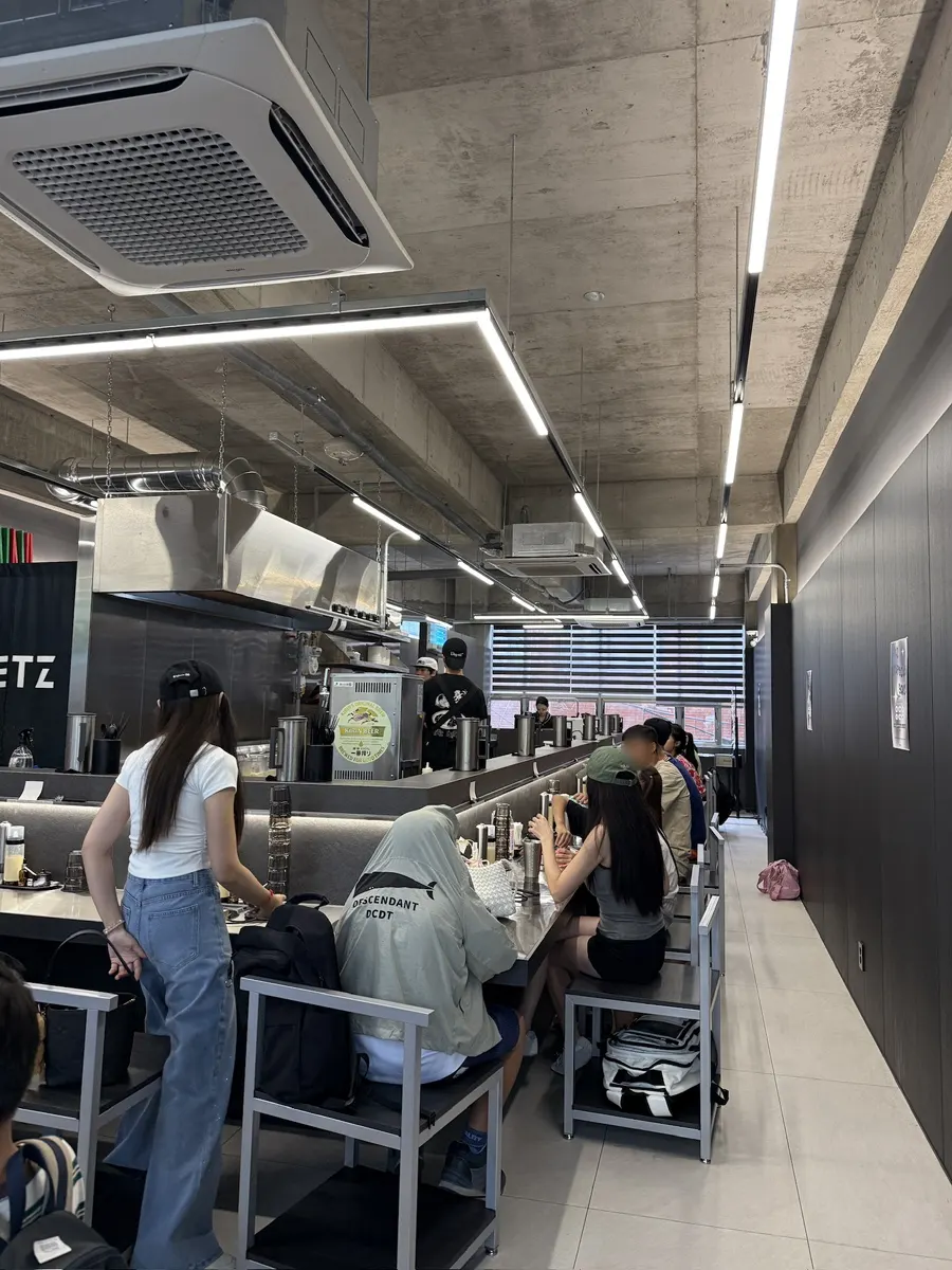Restaurant interior full of lunchtime customers
