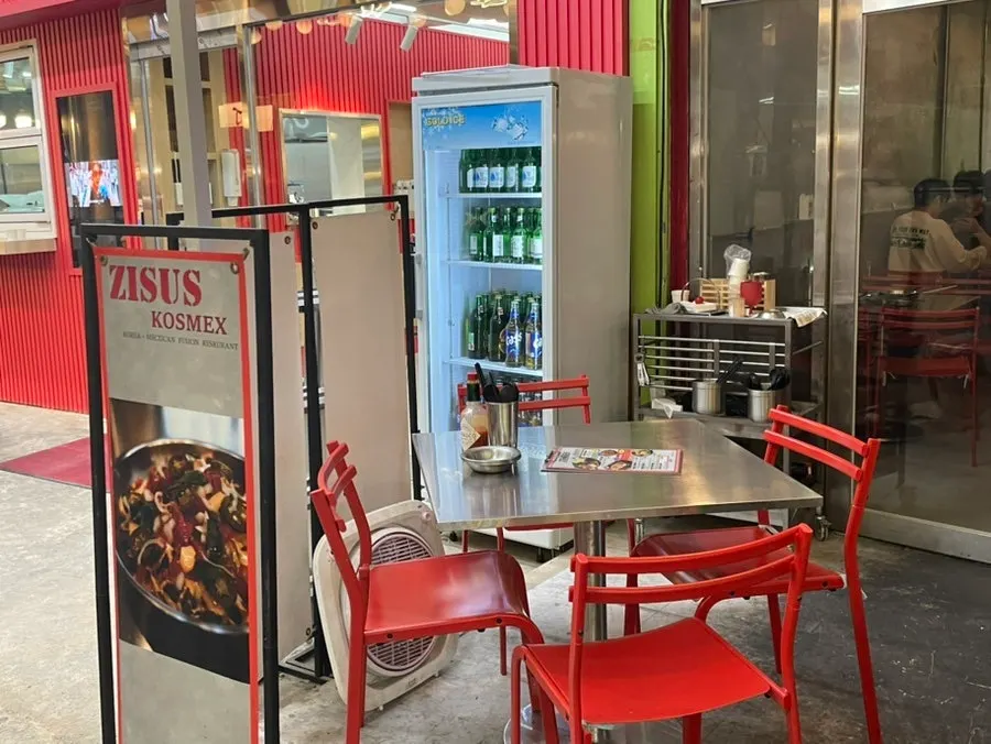 Outdoor tables at Jjeojeoseu with the market street in view