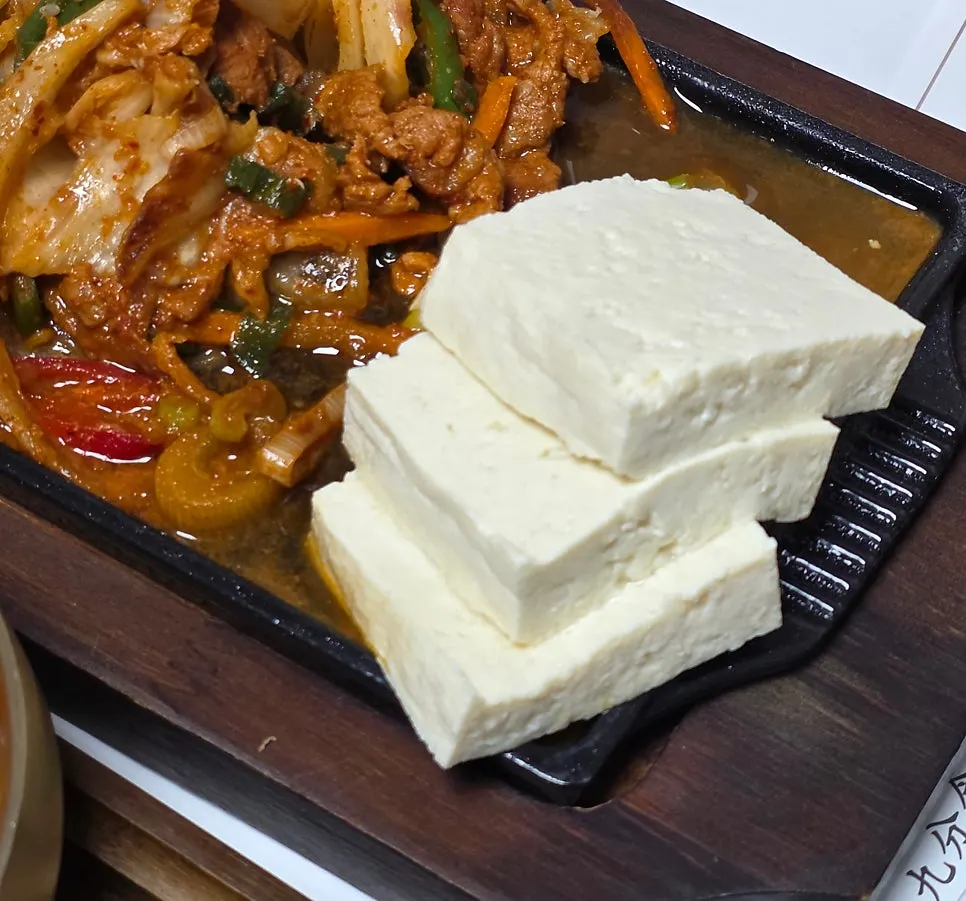 Two bowls of turmeric rice served with the hot pot