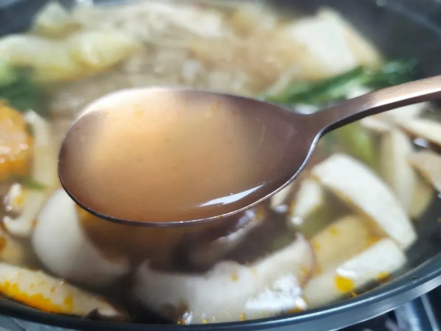 The hot pot simmering with mushrooms and vegetables