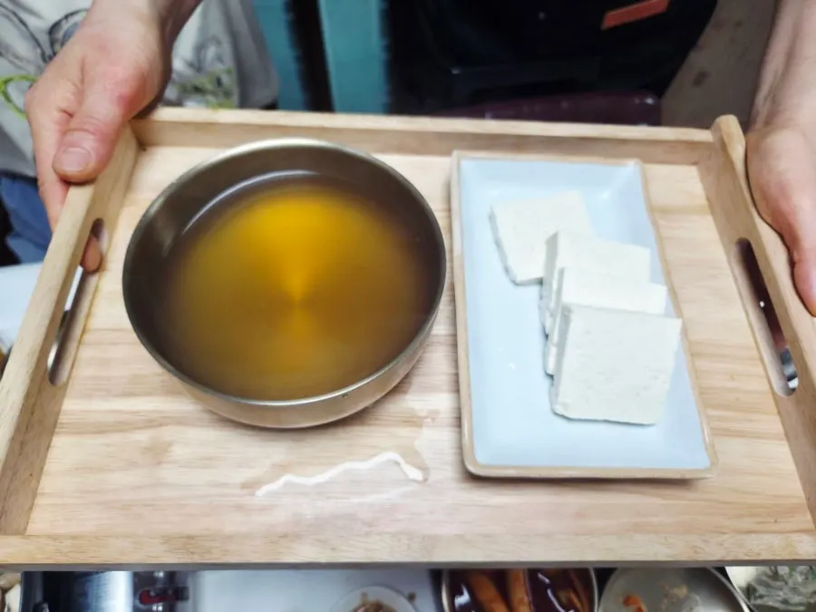The clear broth of the soft tofu hot pot