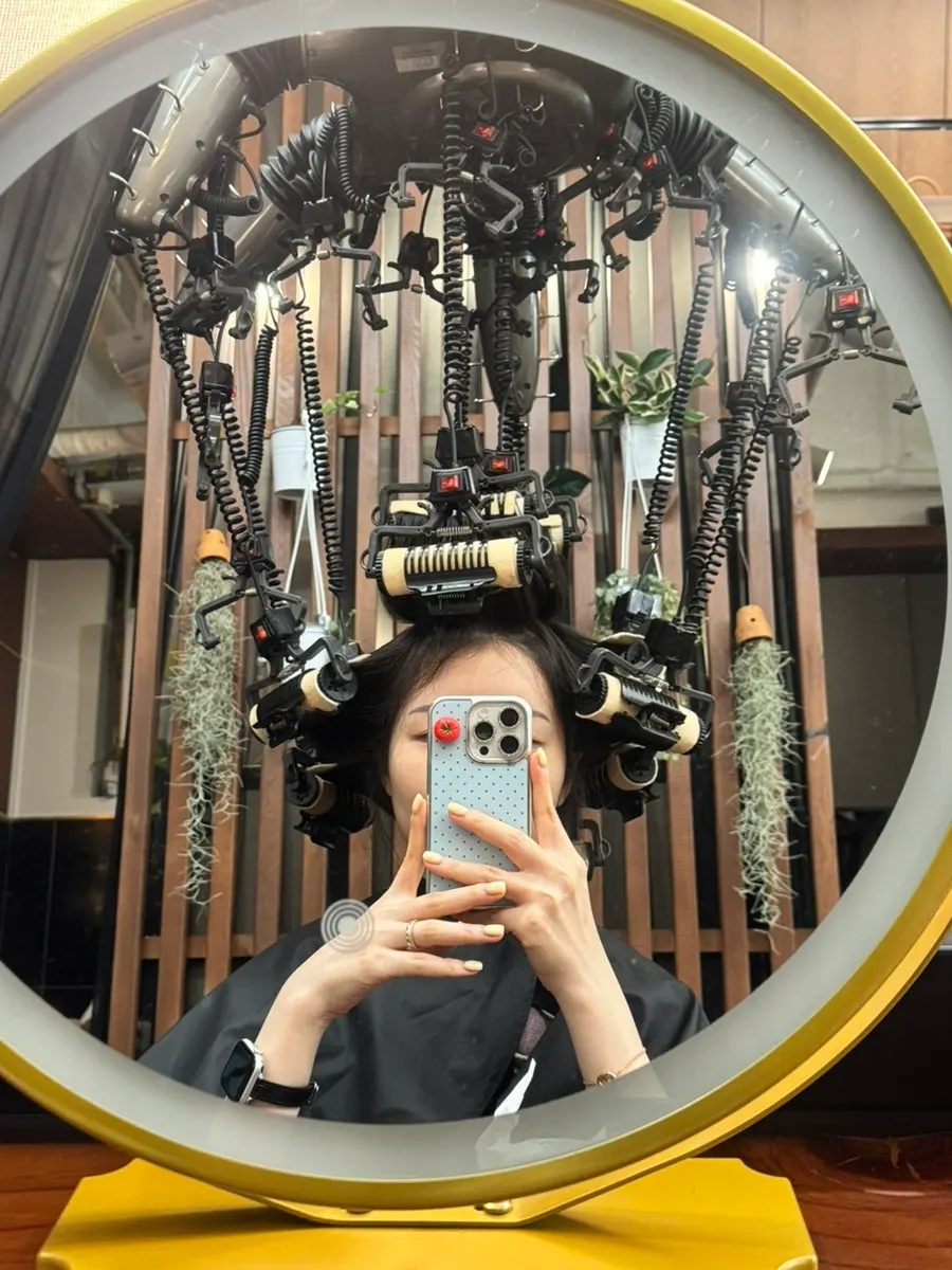 Long hair partway through the perm process