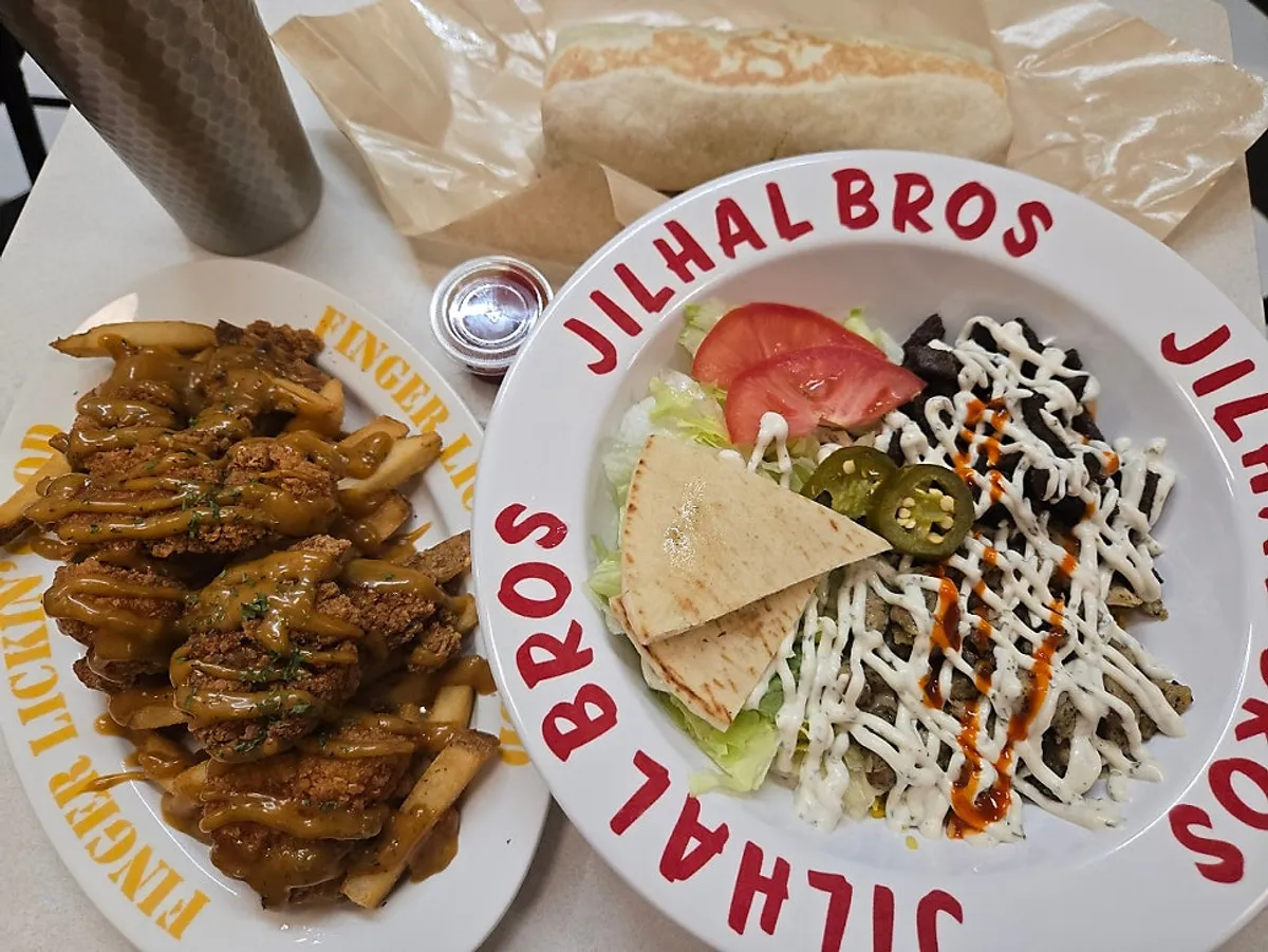 Full spread of combo rice, chicken burrito, and chicken tender and fries