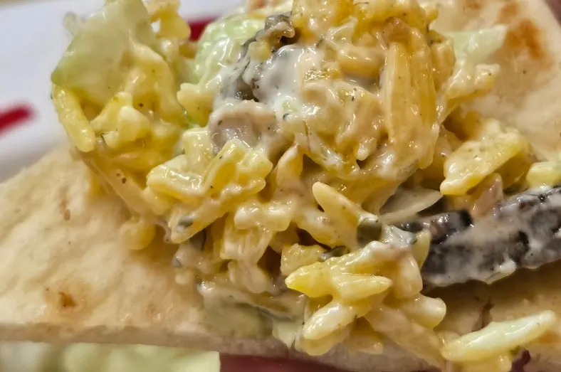 Eating combo rice wrapped in a tortilla