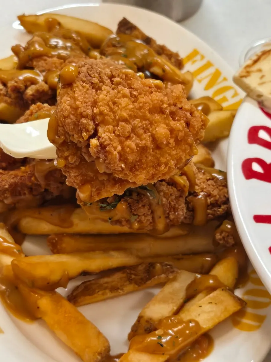 Freshly fried chicken tender and fries