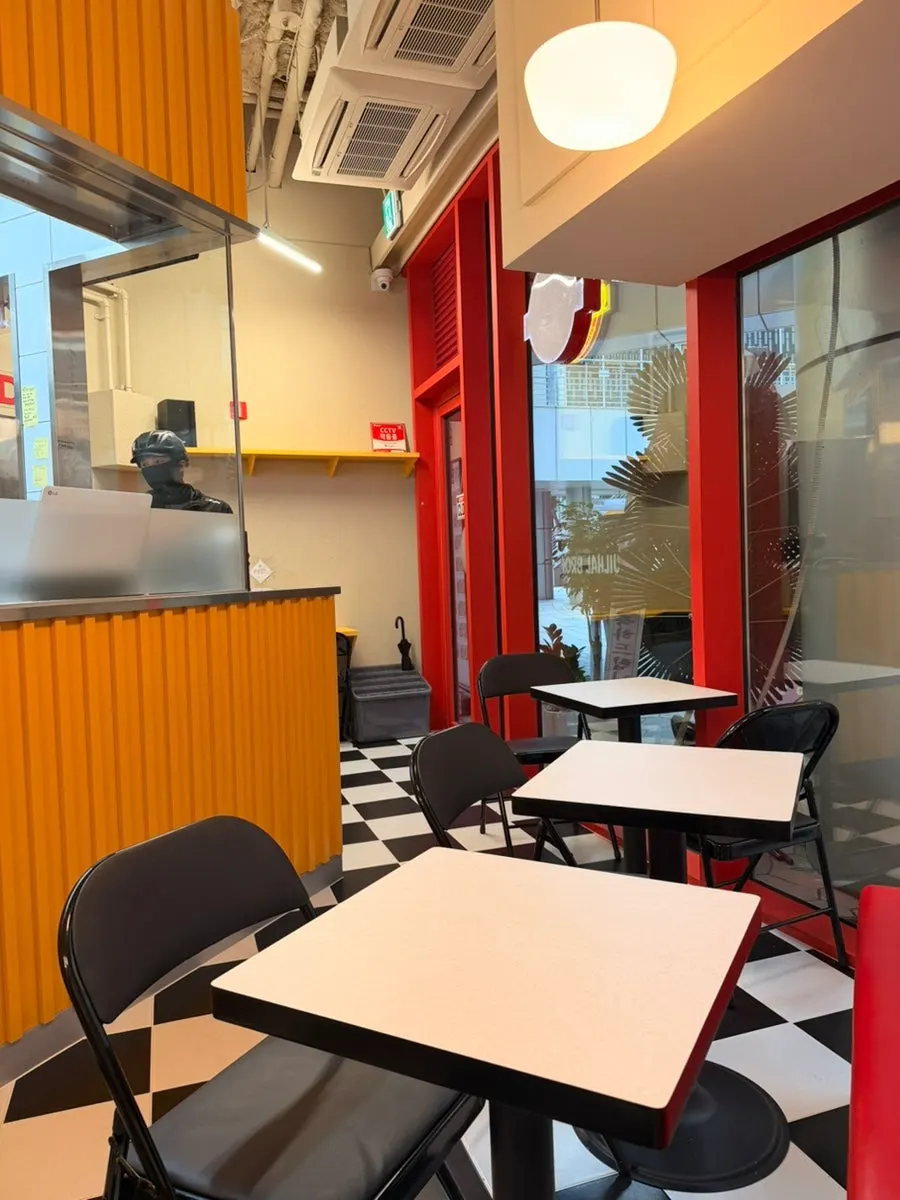 Diner-style restaurant with black-and-white checkerboard floor tiles