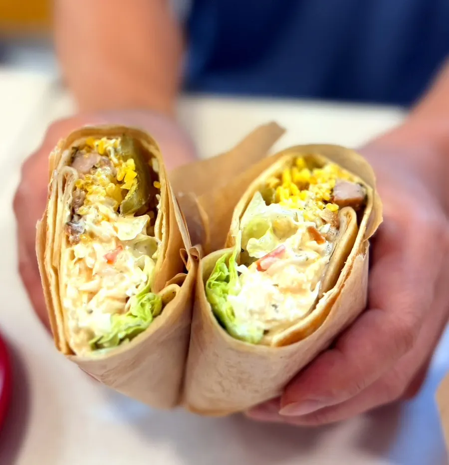 Cross-section of a chicken burrito packed with cubed chicken
