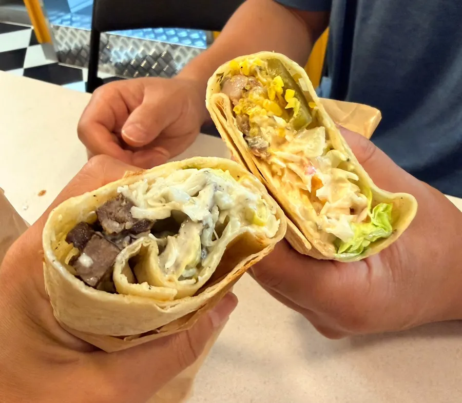 Chicken burrito with sauce dripping out