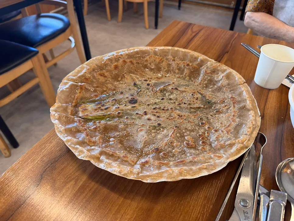 Large buckwheat pancake cut like a pizza