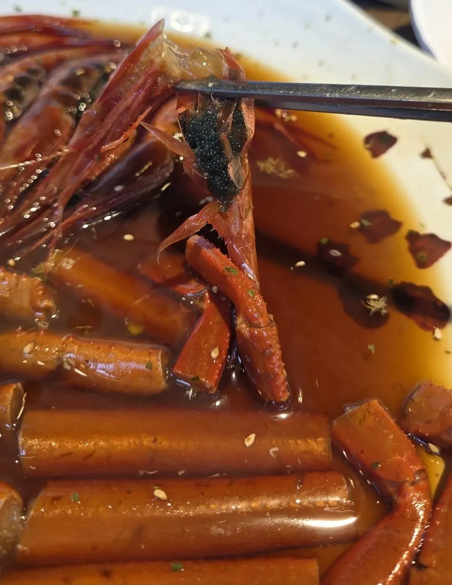 Soy-marinated red crab eaten as a Jin Seiromushi set meal
