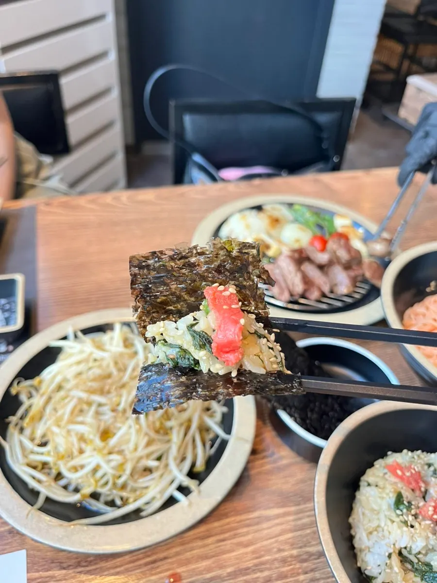 A bite of Jin's signature rice wrapped in seaweed