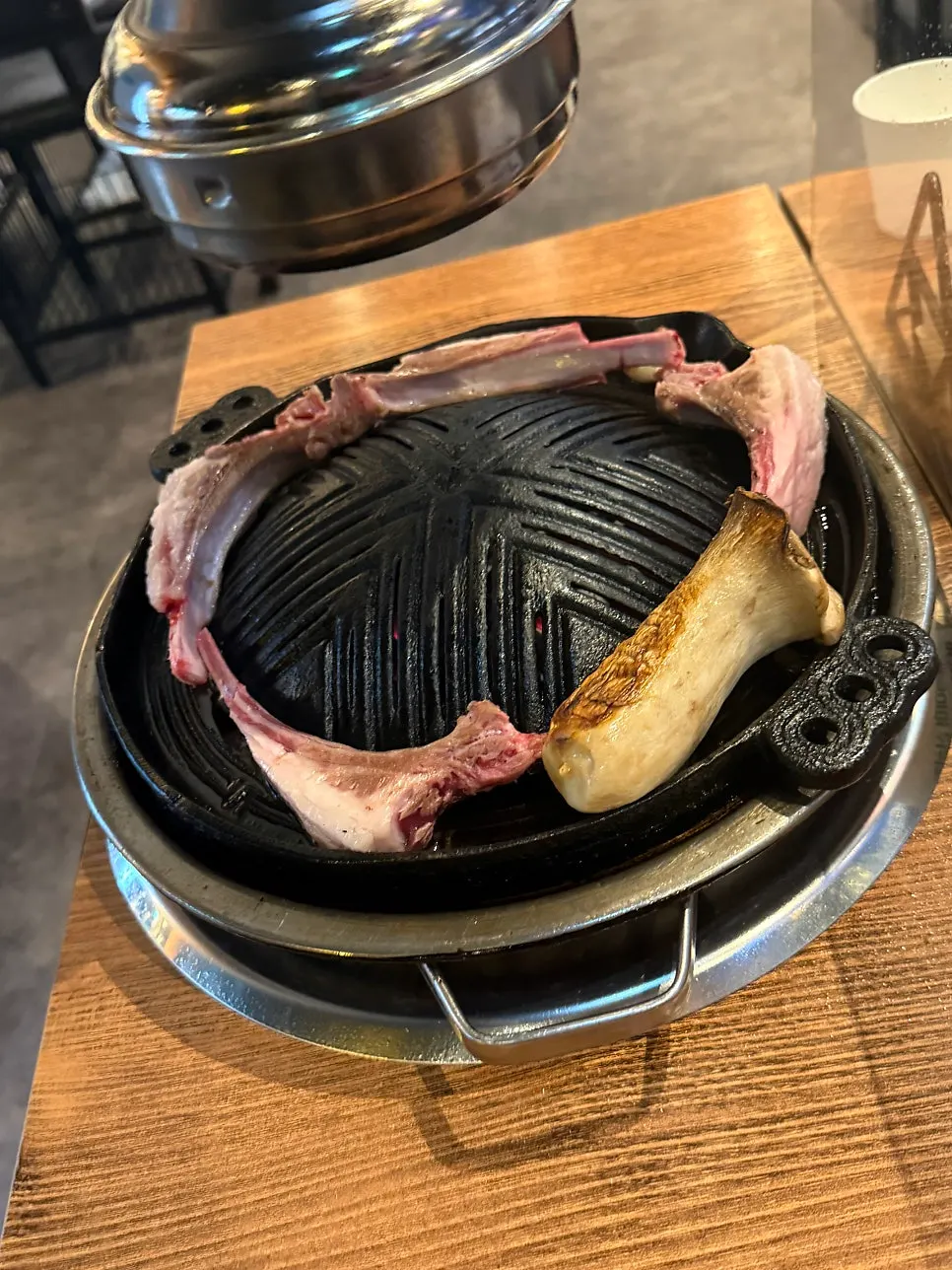 Lamb chop bone wrapped in paper for easy handling