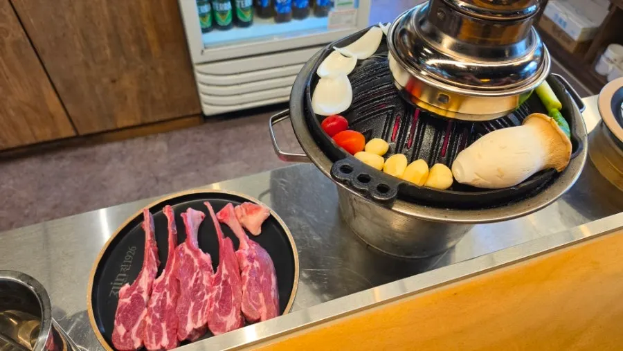 Lamb chops placed on the grill and beginning to cook
