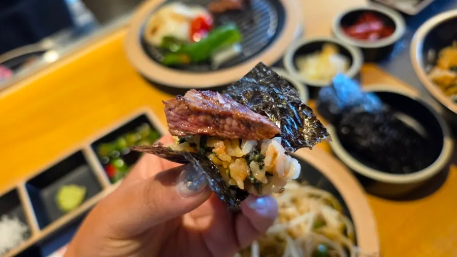 A piece of lamb chop dipped in Maldon salt and wasabi