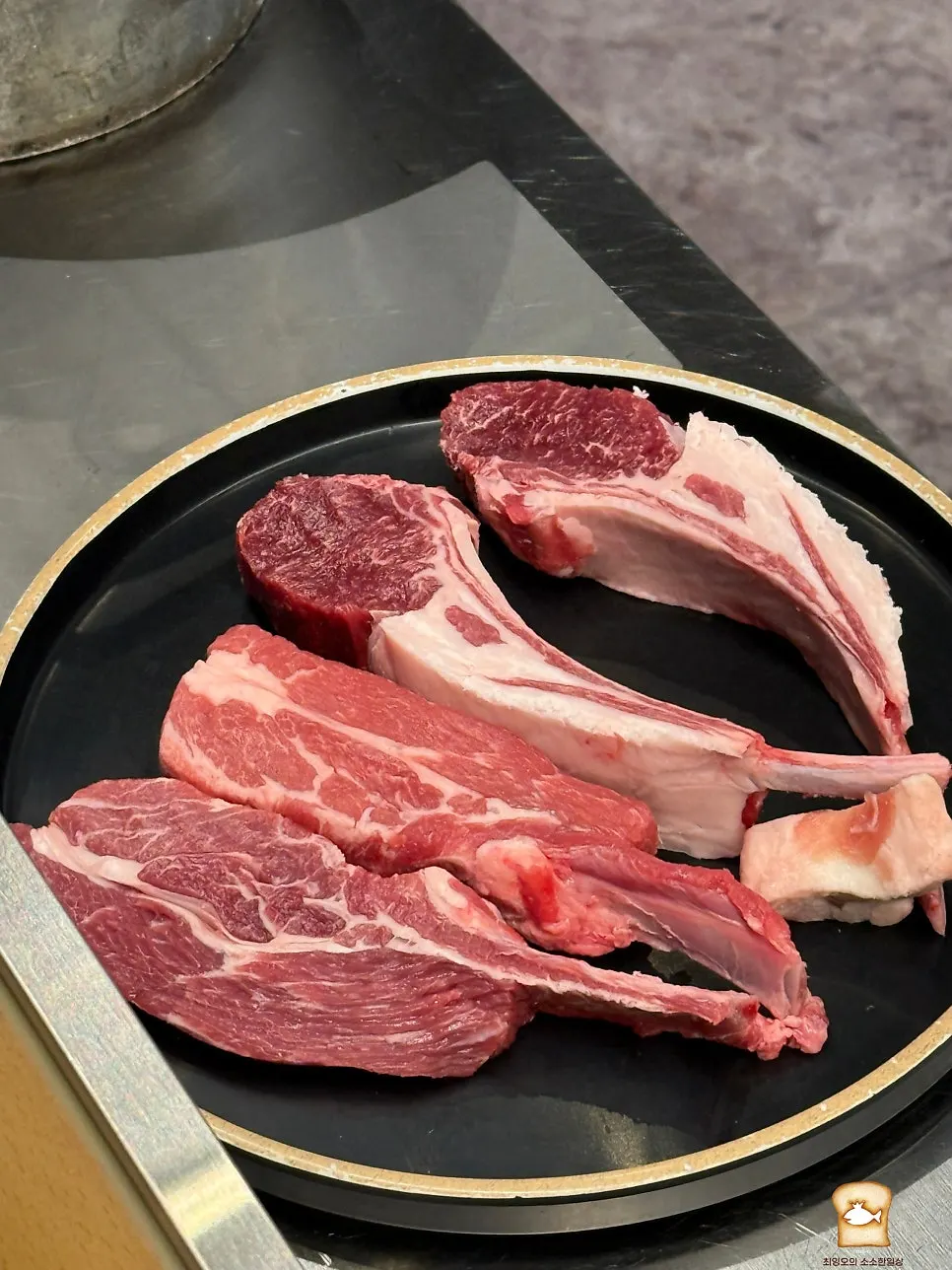 Raw French rack and lamb ribs set up for grilling