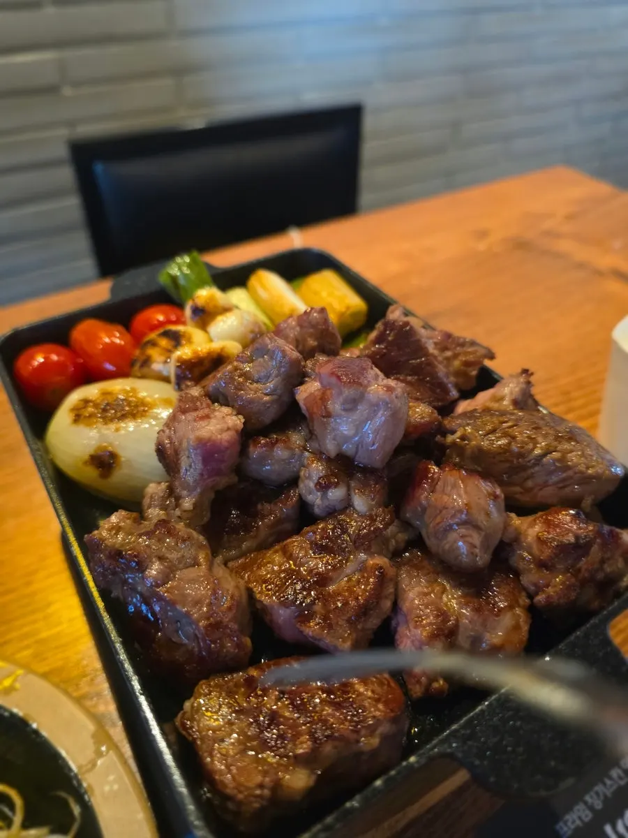 Cast-iron pot for grilling lamb ribs beside the glass partition