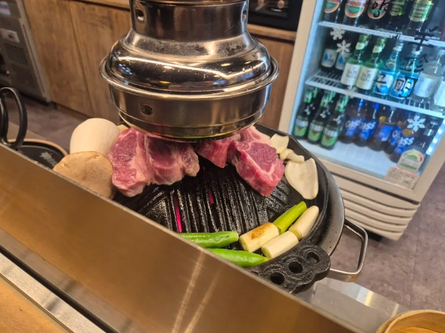 French rack and lamb ribs grilling on the tabletop grill