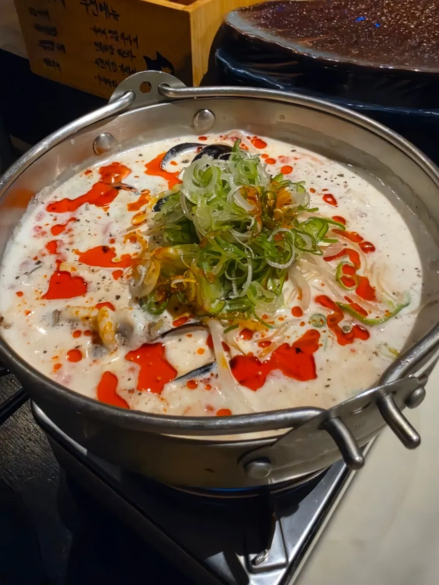 Cream jjamppong broth topped with chili oil