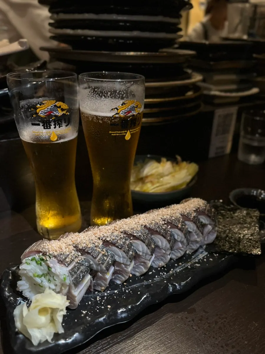 Side view of the thick, generously topped mackerel pressed sushi