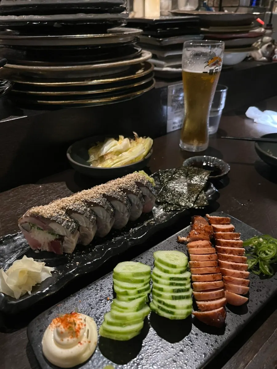 Table spread with grilled pollock roe and mackerel pressed sushi together