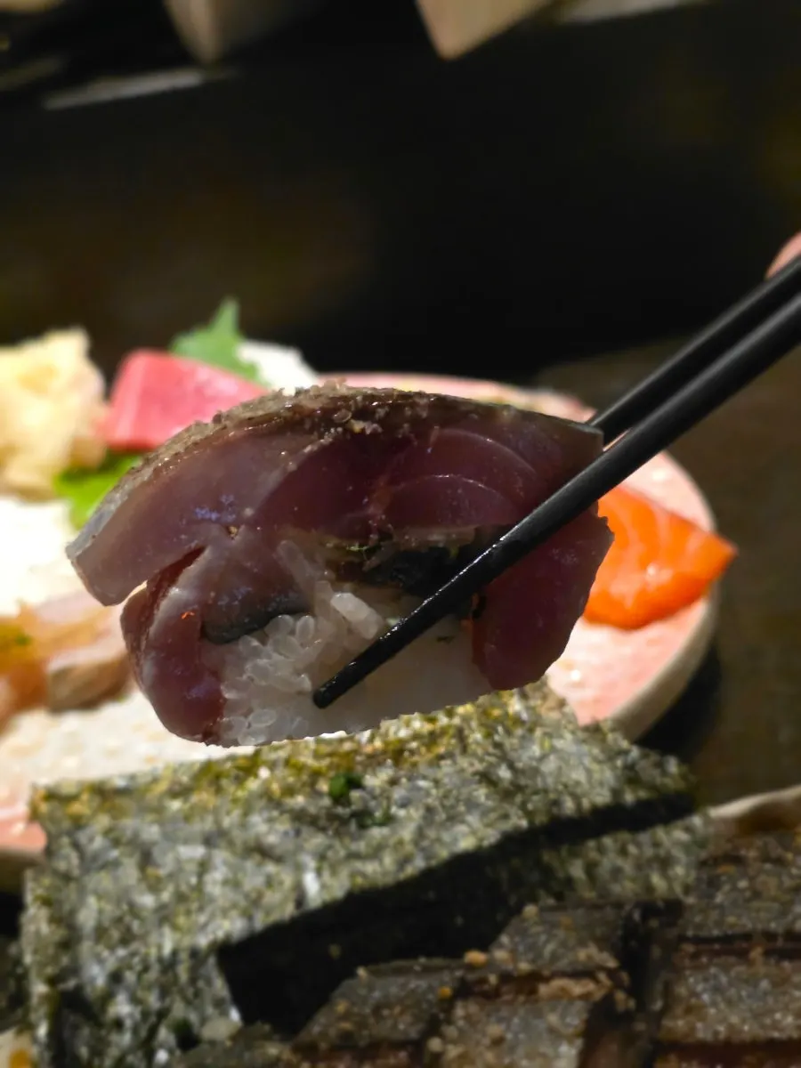 Mackerel pressed sushi compared in size to a wrist