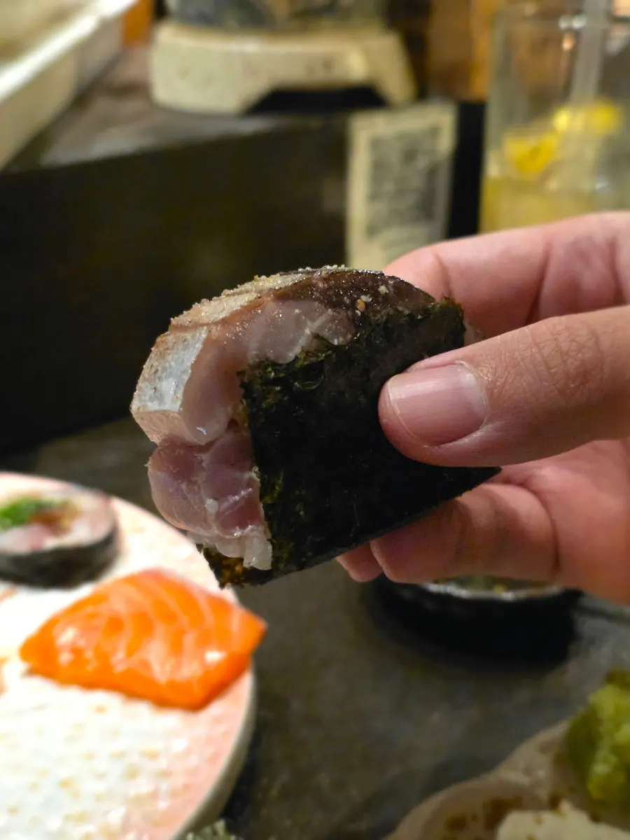 Mackerel pressed sushi served with soy sauce and wasabi