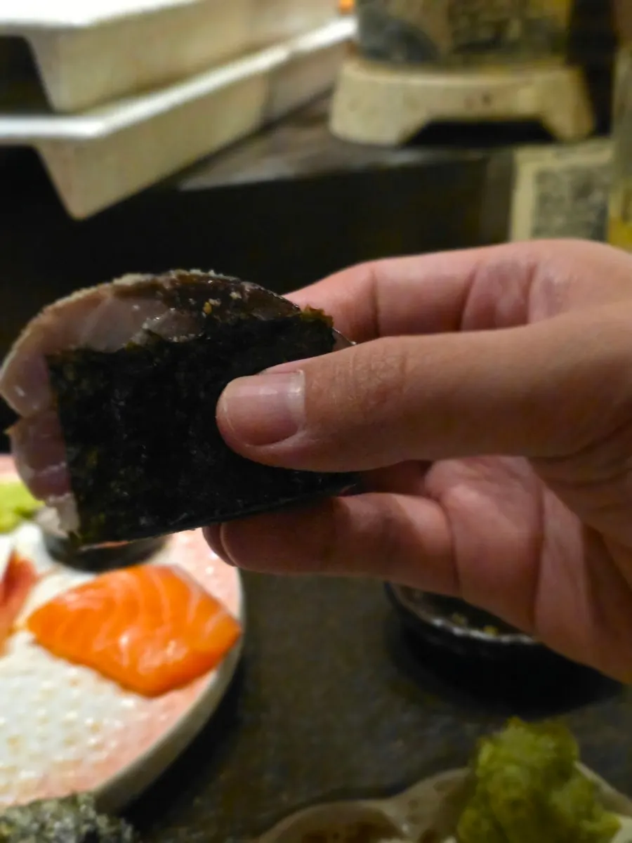 Eating mackerel pressed sushi wrapped in seaweed