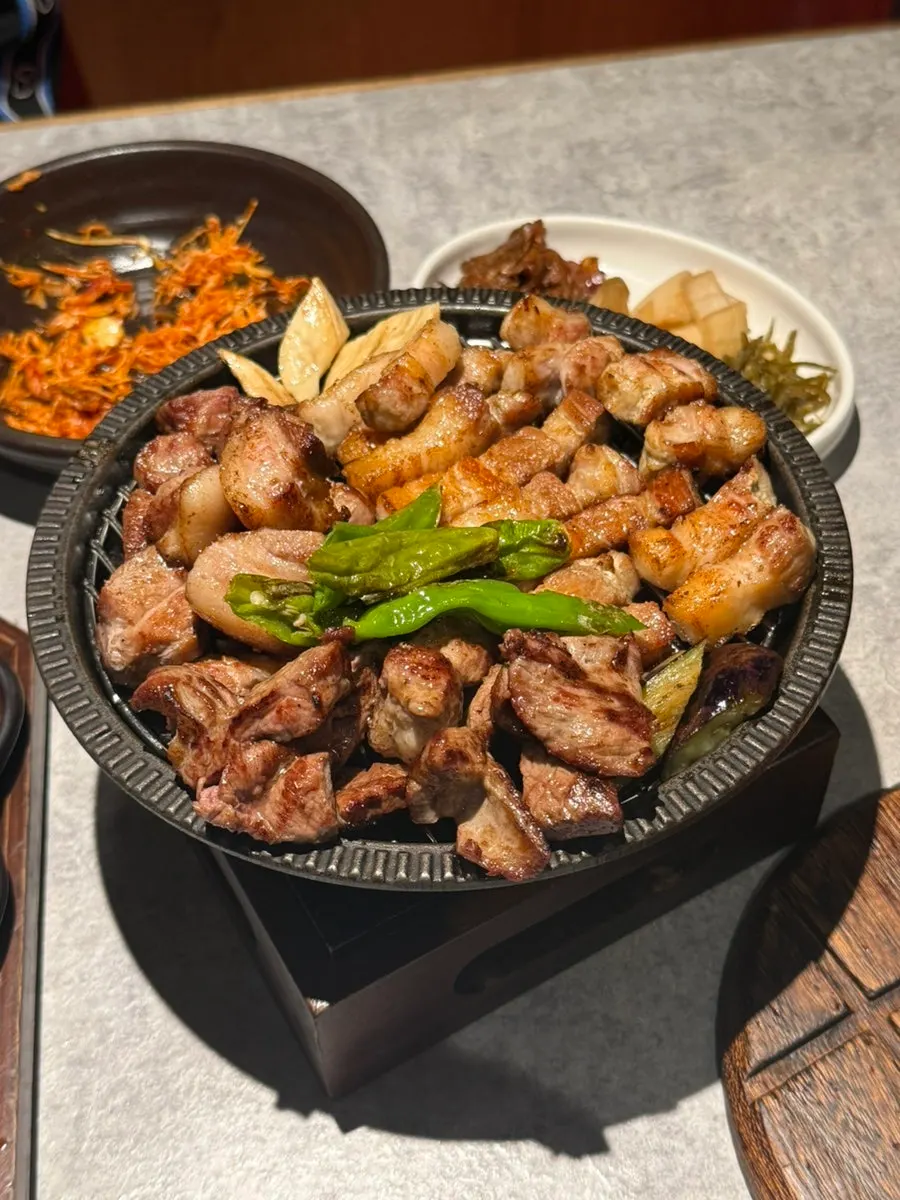 A staff member grilling the whole-pig set