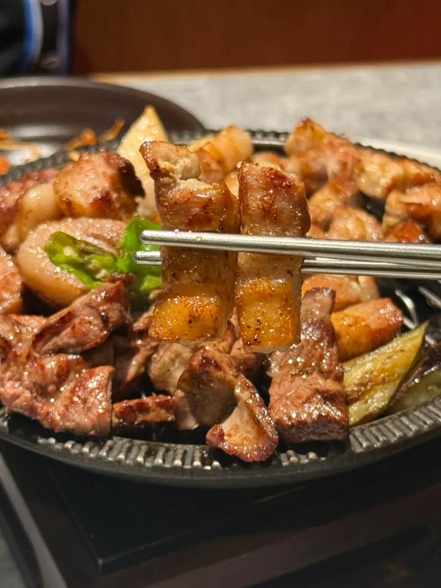 Grilled meat transferred to a small brazier