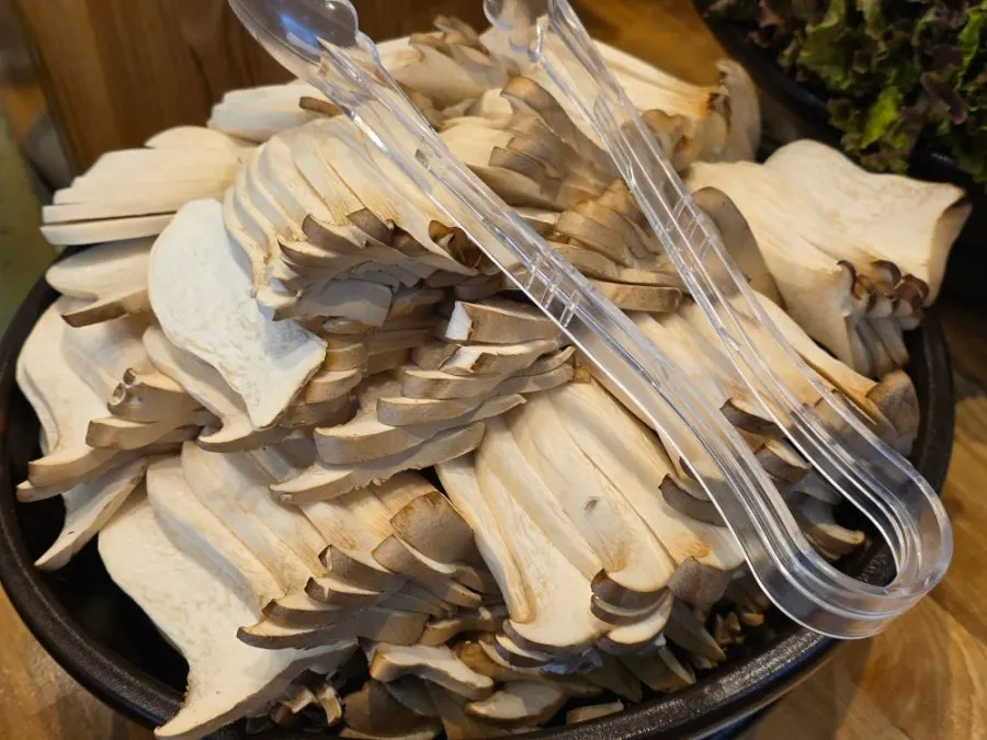 A mountain of king oyster mushrooms and wrapping greens