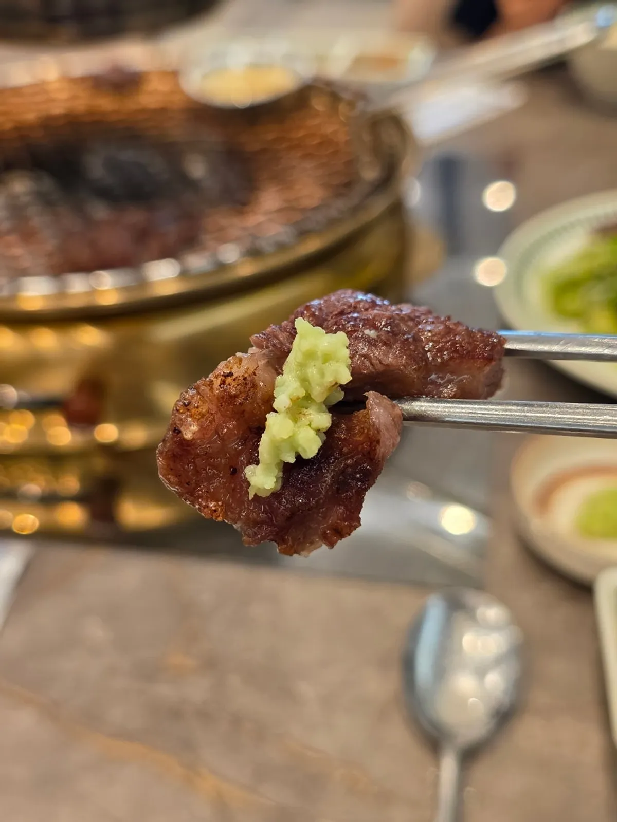 A full spread of charcoal-grilled flower marbled ribeye at Geum Songaji