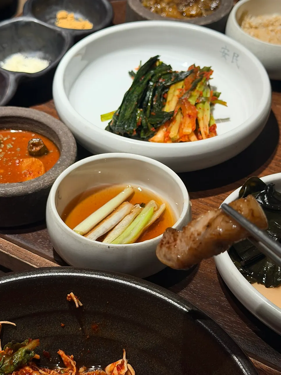Dipping grilled pork belly into sauce
