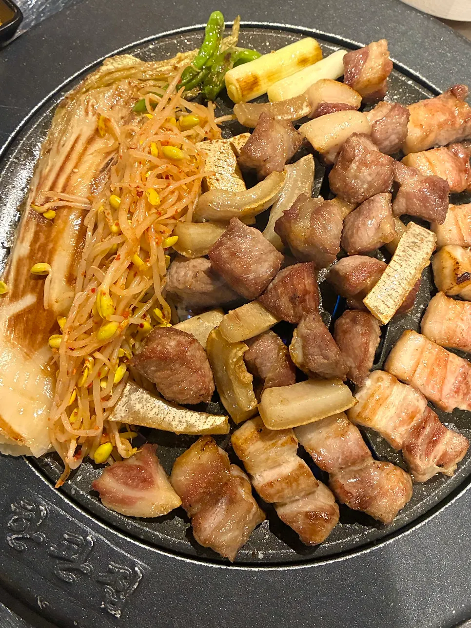 Bean sprouts and white kimchi grilled together on the platter