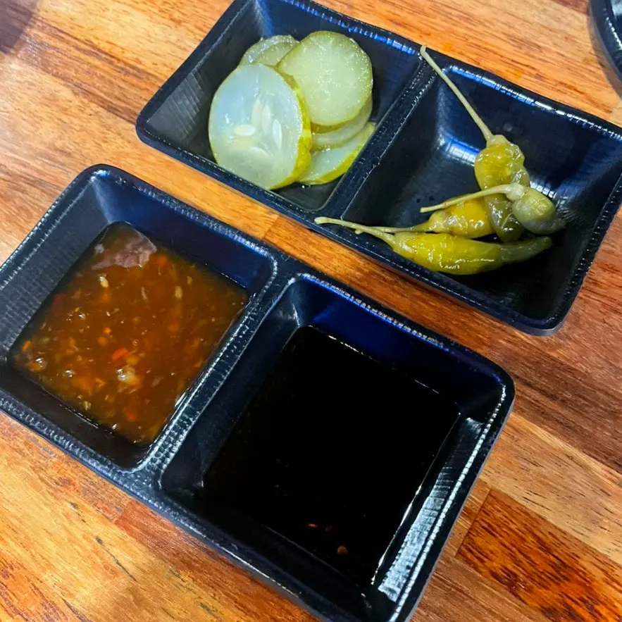 Basic side dishes with pickles, peppers, and sauces