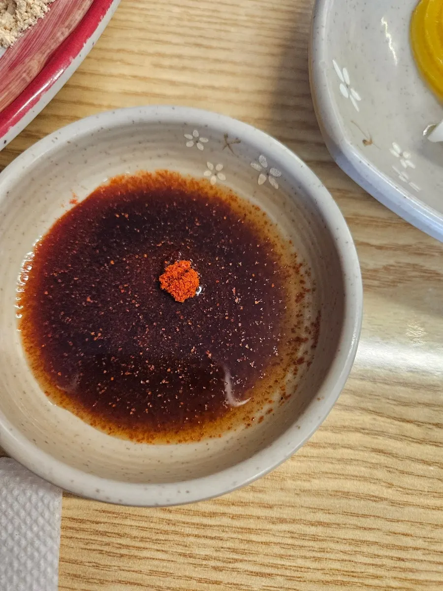 Soy sauce dish and utensils on the table