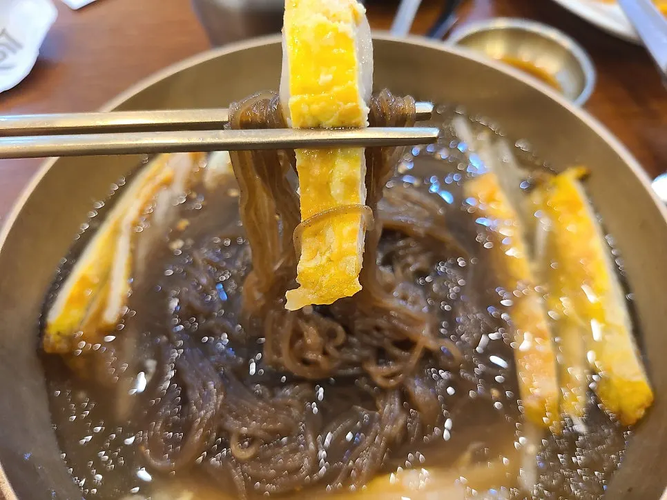 Checking the broth of the water naengmyeon