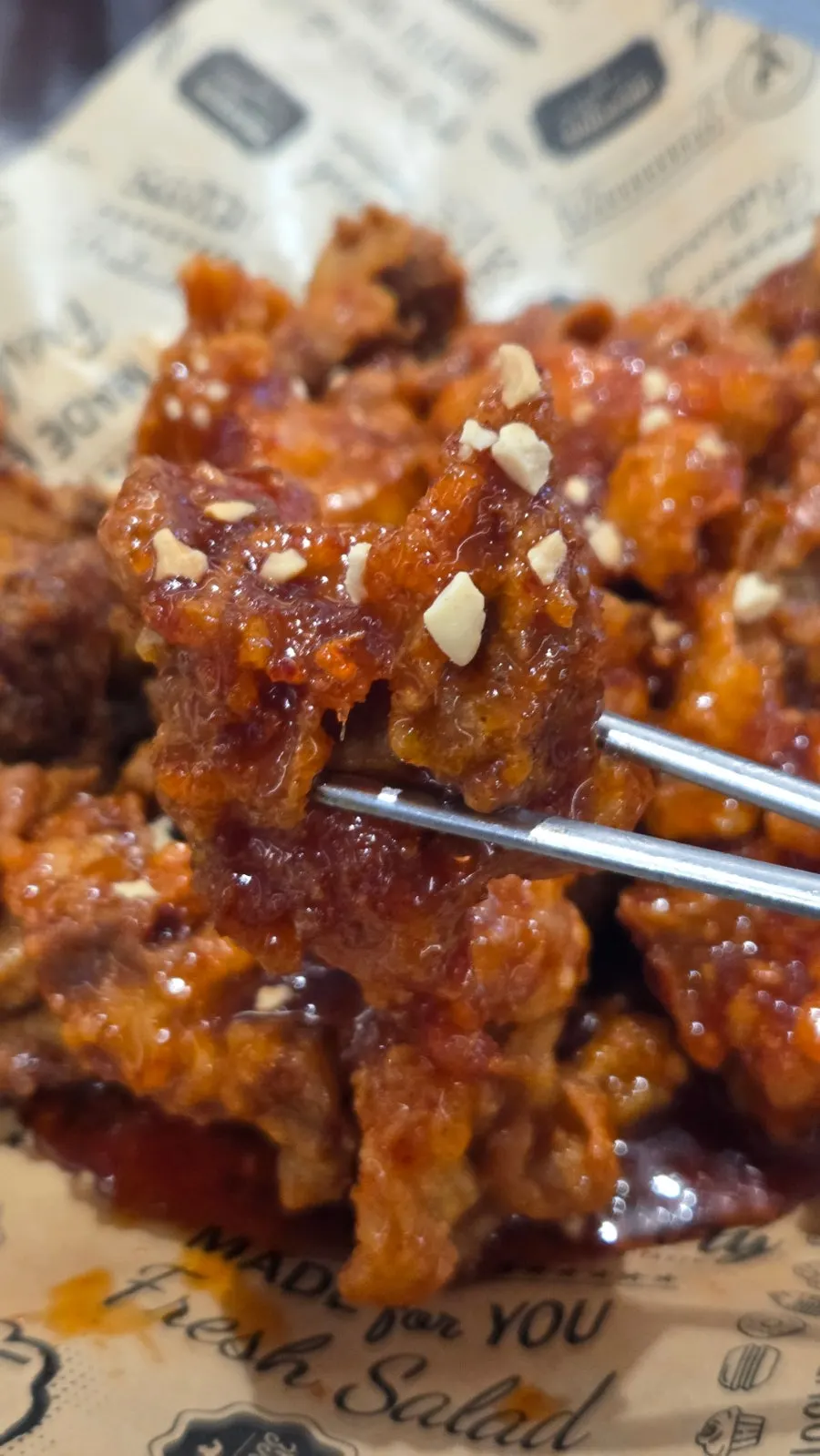 Boneless seasoned chicken evenly coated in sauce