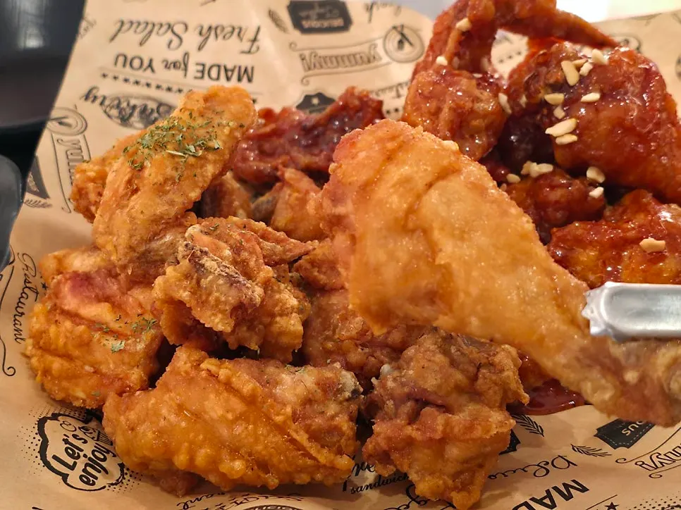 A plate of half-and-half fried and seasoned chicken