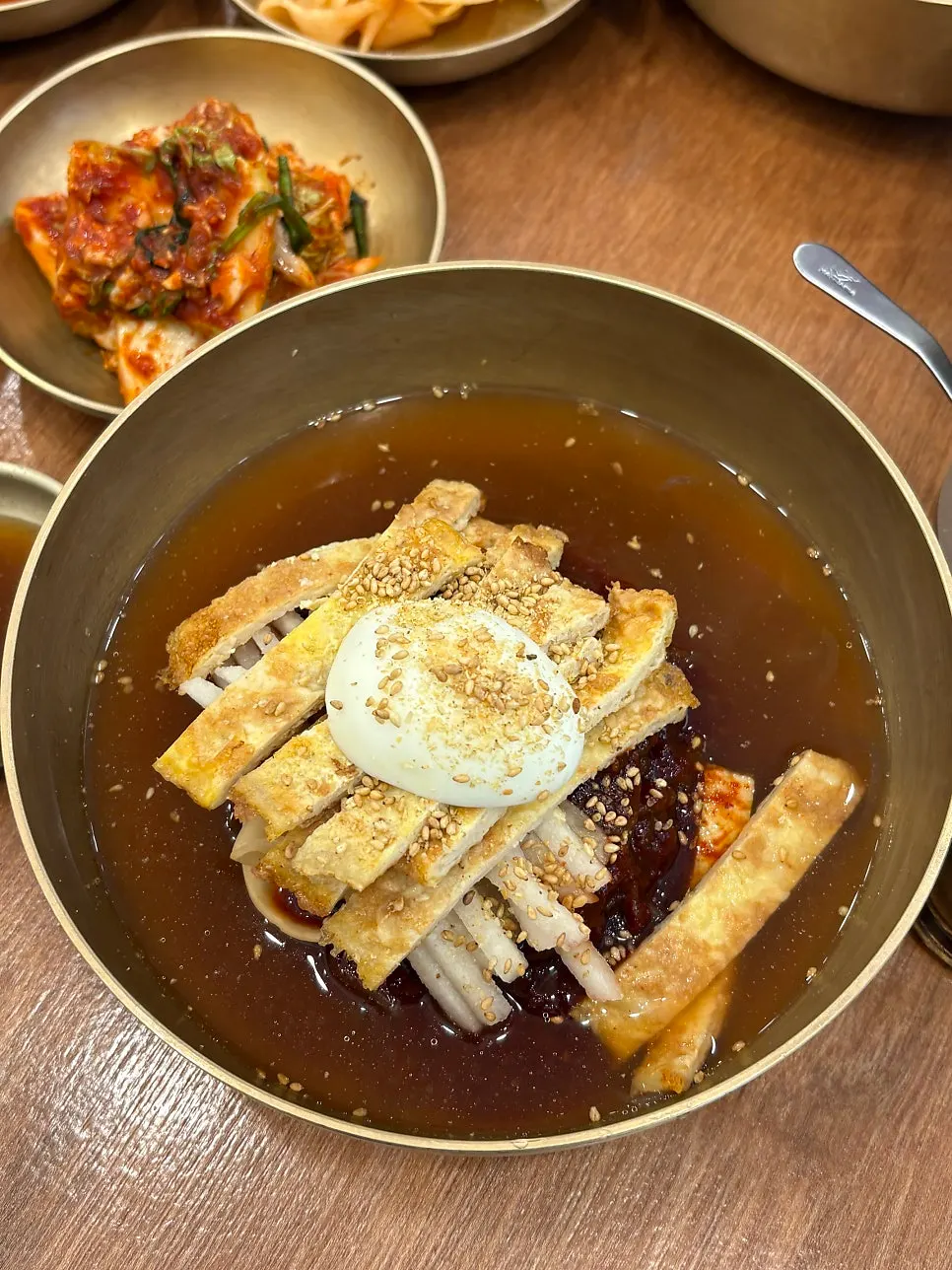 Mul-naengmyeon broth topped generously with yukjeon
