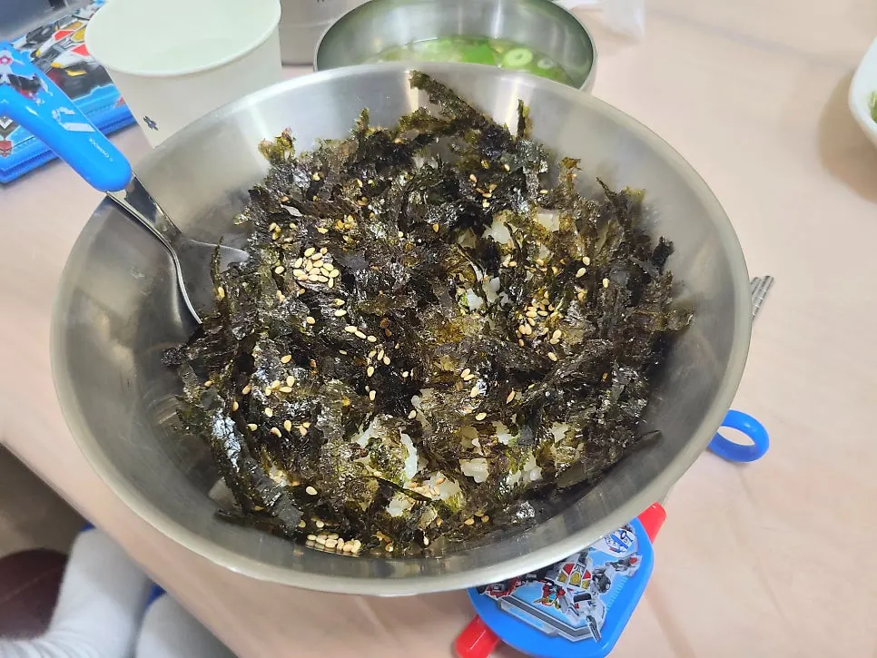 Rice piled with seaweed flakes for a child