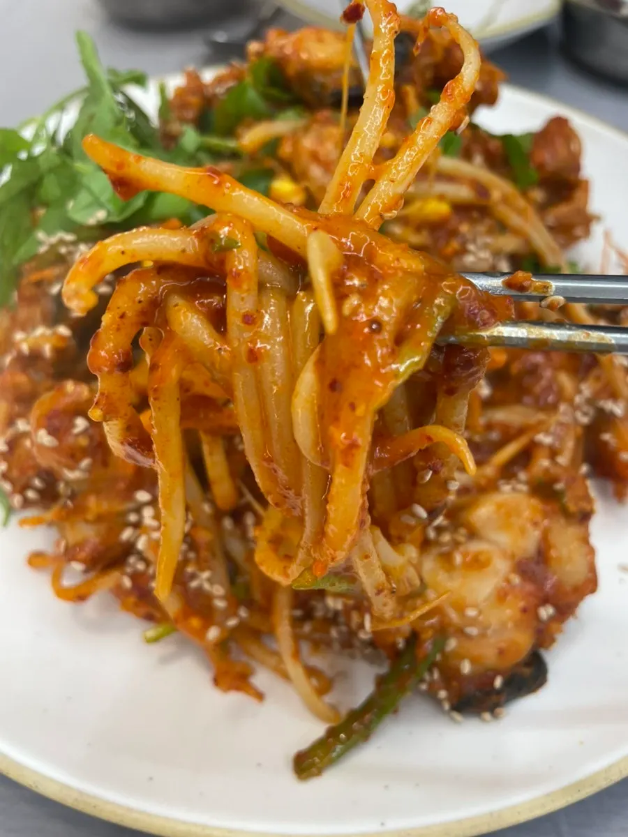 Crisp bean sprouts visible in the monkfish stew