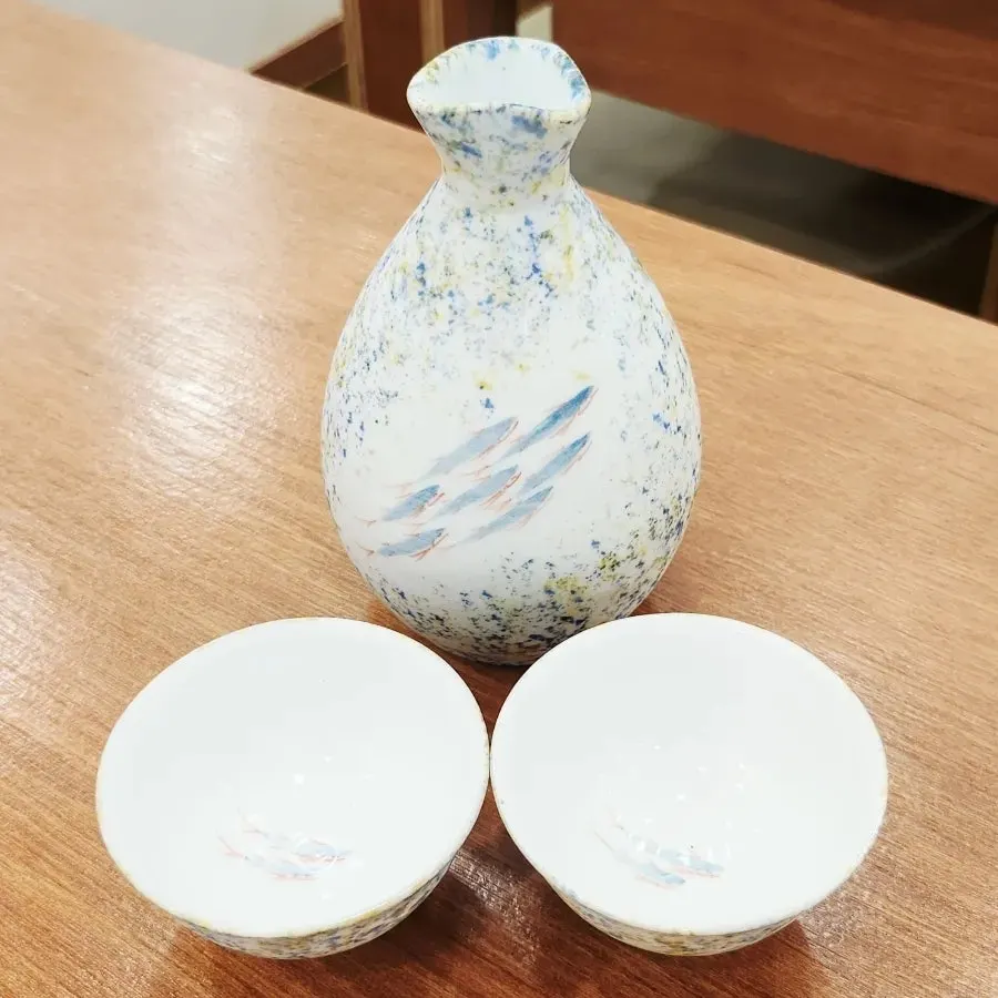 Bottle and glasses painted with fish designs