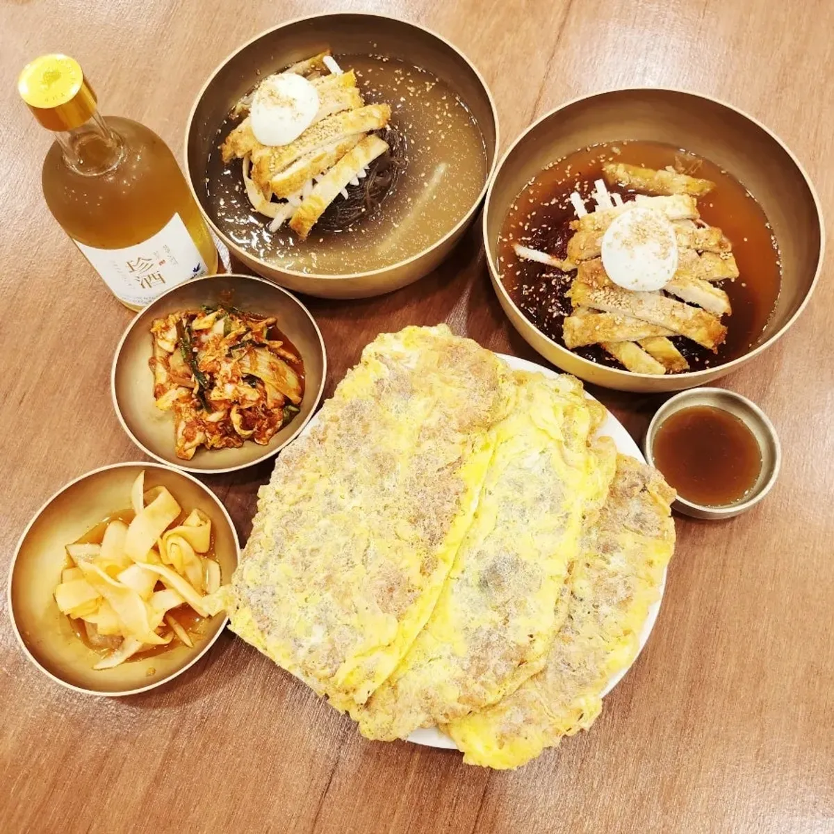 Table with naengmyeon, yukjeon, and doraji-ju together
