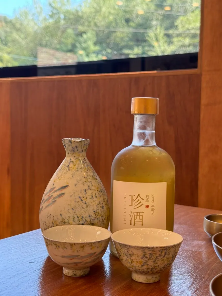 Bottle and glass of Jinju Jangsaeng Doraji-ju
