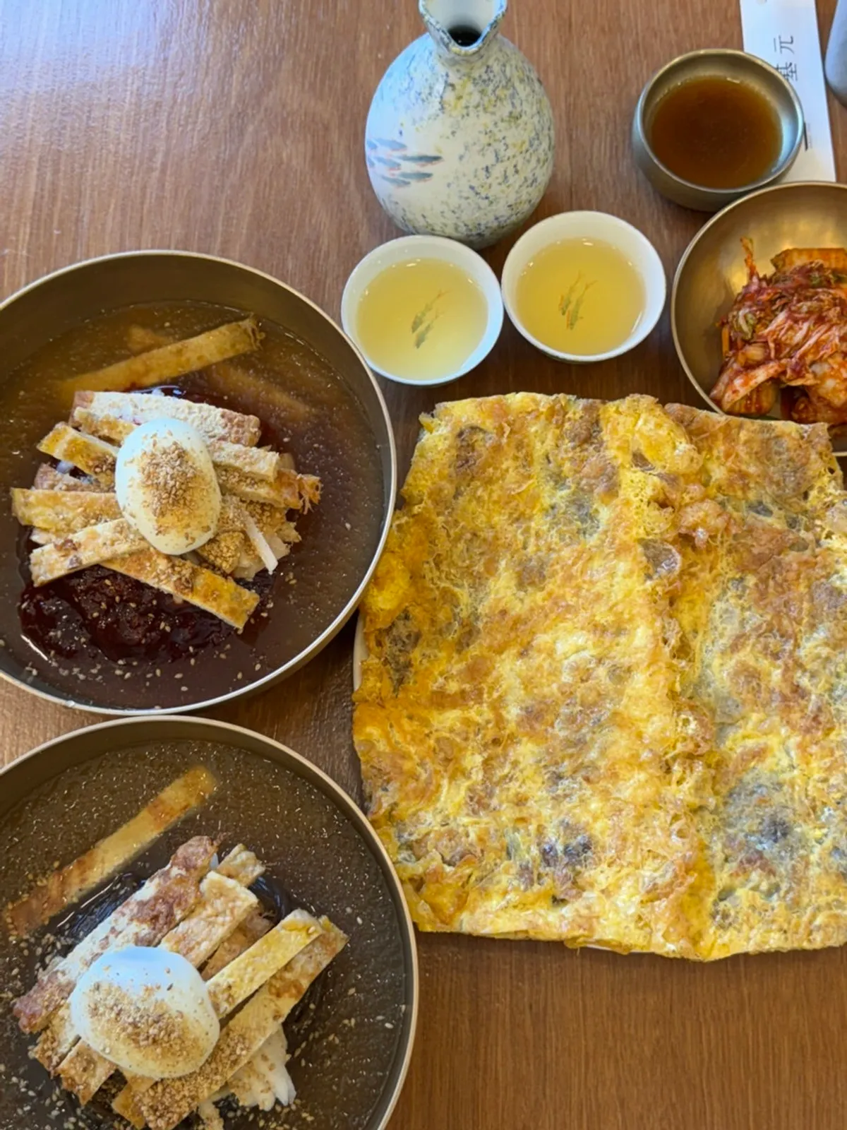Table spread with naengmyeon and yukjeon