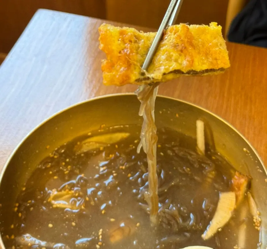 A refilled cup of warm broth
