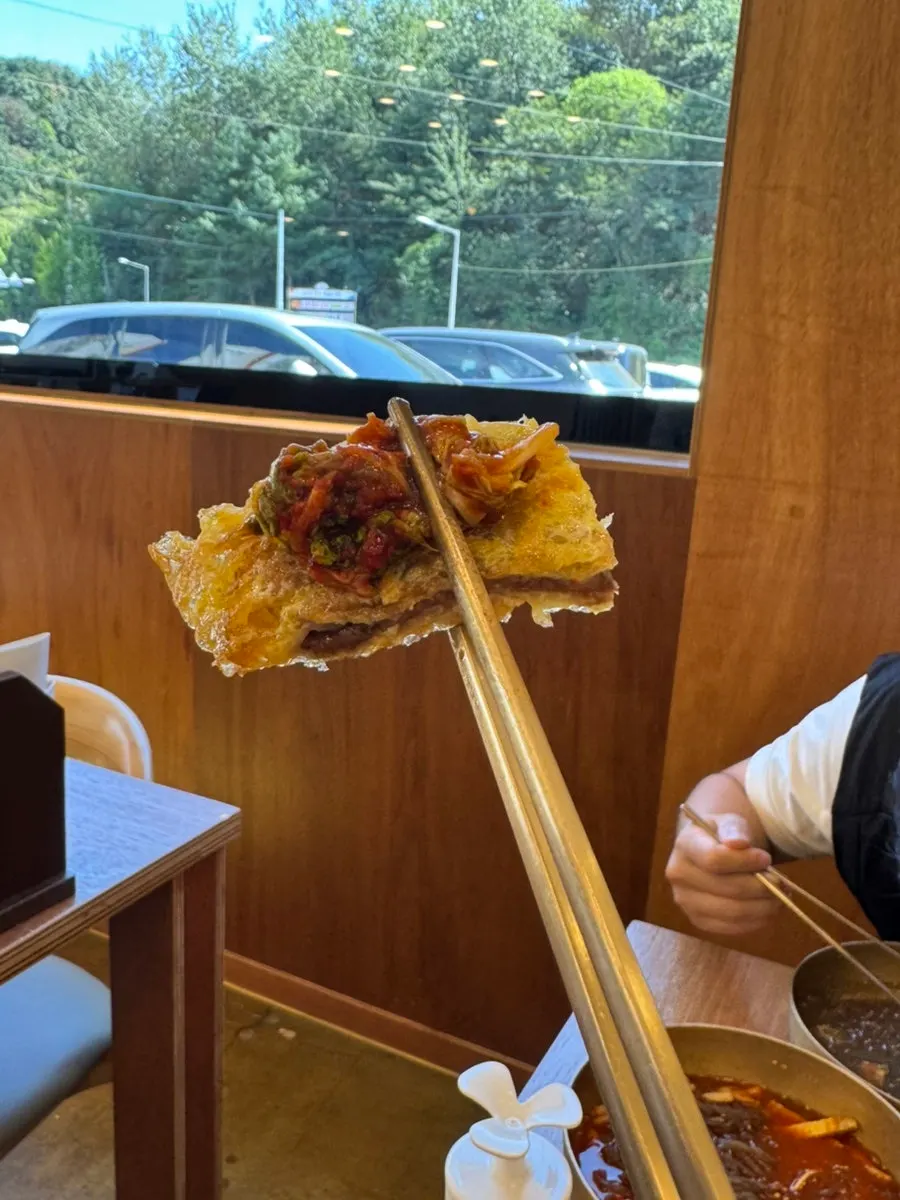 Table with naengmyeon, yukjeon, and doraji-ju