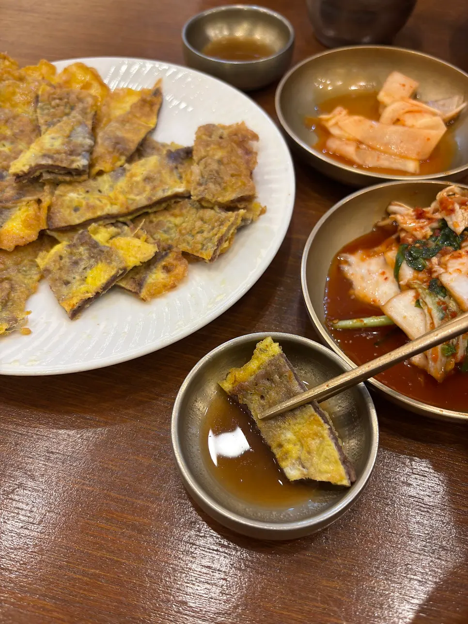 Dipping yukjeon into sauce