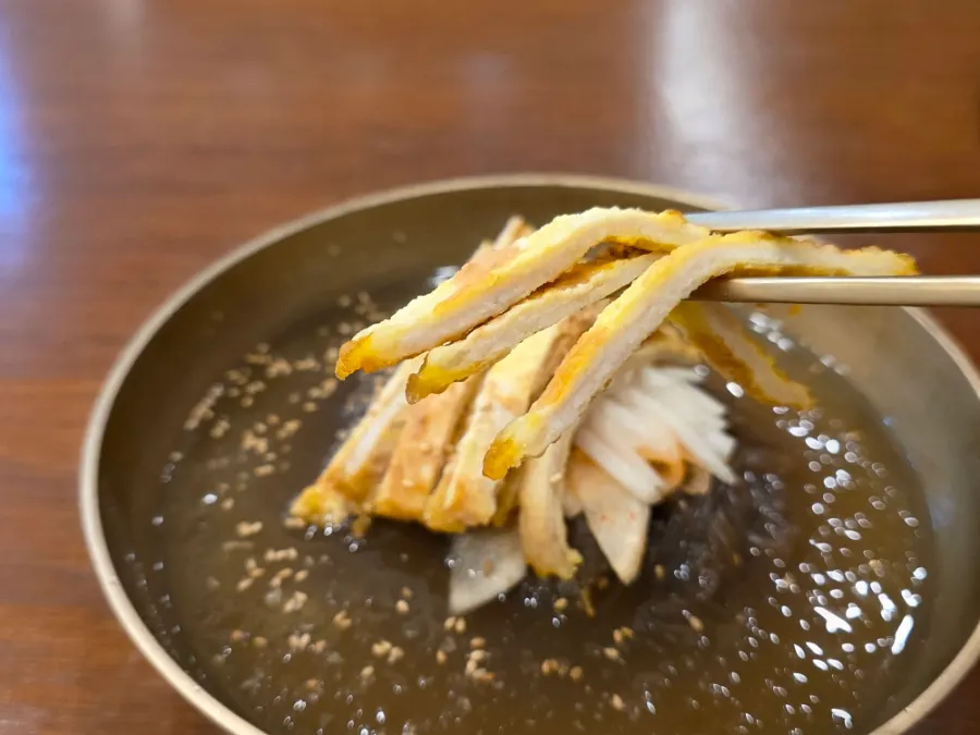 Jinju naengmyeon topped with beef yukjeon