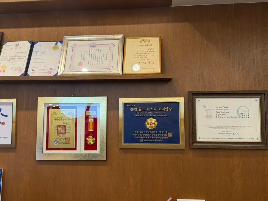 Korean Cuisine Master and Chef Master certificate plaques on display